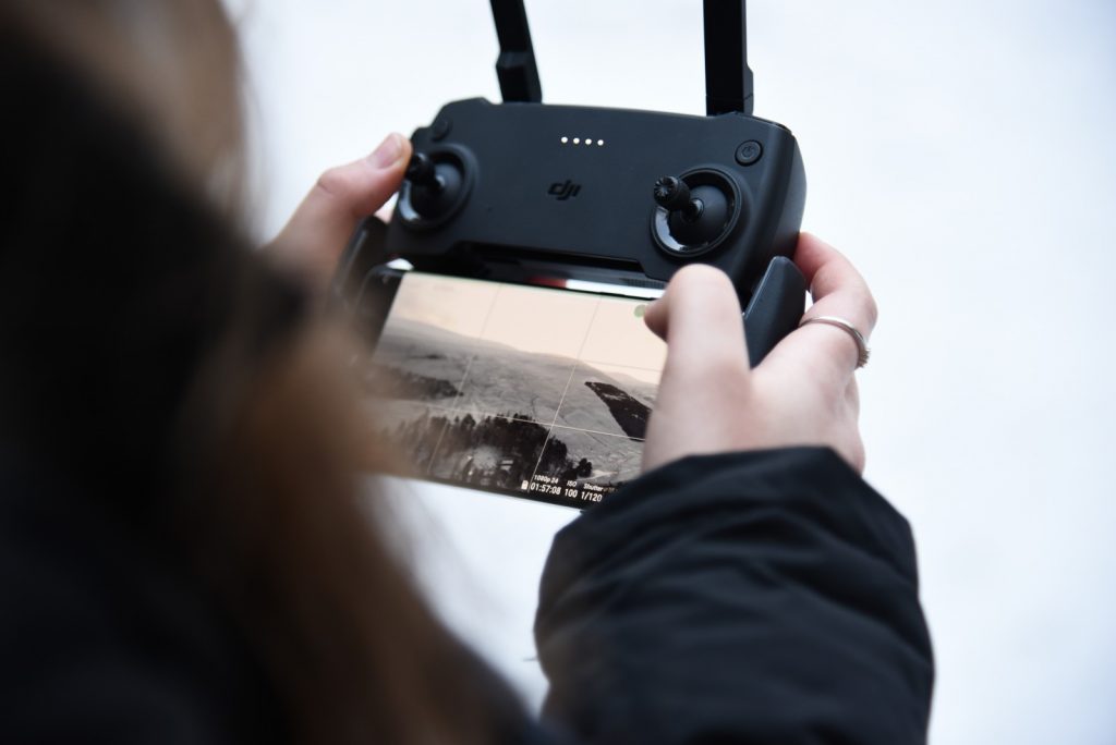 Over the shoulder shot of Erin controlling her drone in Aberdeenshire